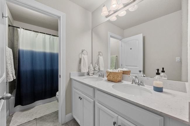 Full bath featuring double vanity and tile patterned flooring | Image 25