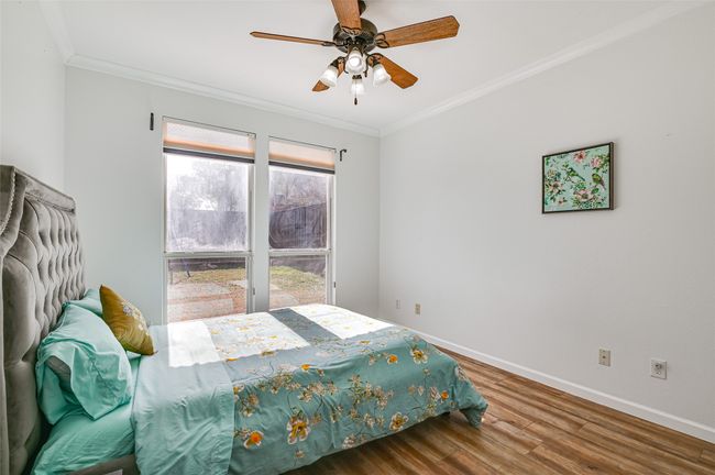Bedroom featuring ceiling fan, ornamental molding, and hardwood / wood-style floors | Image 25