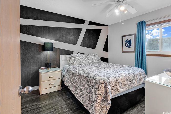 Bedroom featuring dark wood-type flooring and a ceiling fan | Image 4