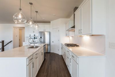 (Photo of similar home, finishes may vary) The kitchen overlooks the dining room for an easy transition between cooking and mealtime | Image 2