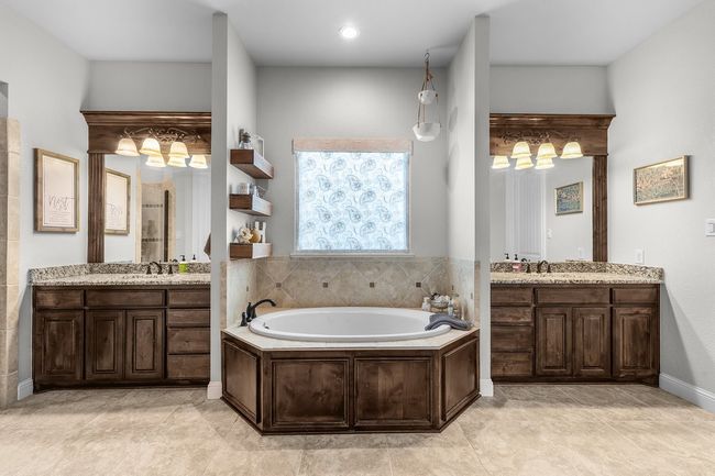 Bathroom featuring a garden tub and two vanities | Image 16
