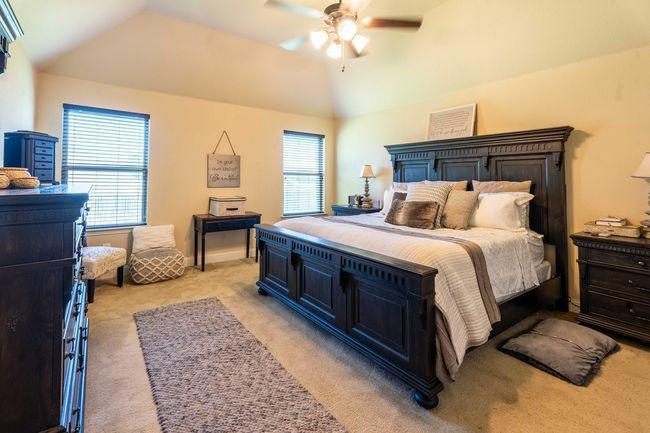 Primary bedroom featuring light carpet and a ceiling fan | Image 20