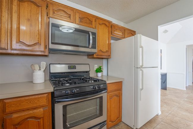 Kitchen featuring a stainless steel gas range and microwave | Image 23