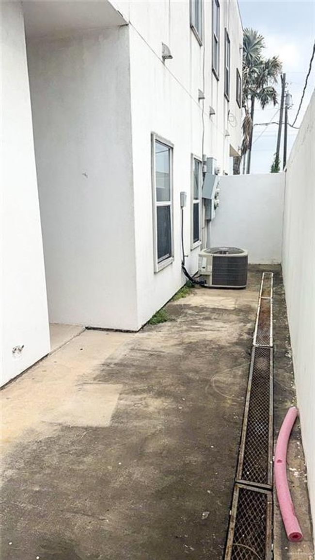 View of patio / terrace with fence and central AC. Great place to grow a Zen garden! | Image 16