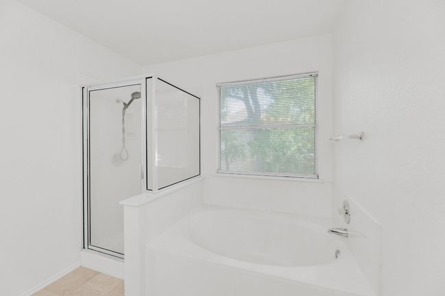 Bathroom with a bath and a stall shower | Image 18