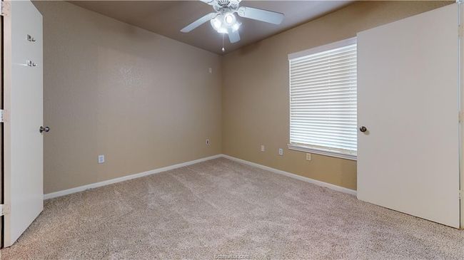Spare room with light carpet, baseboards, and a ceiling fan | Image 7