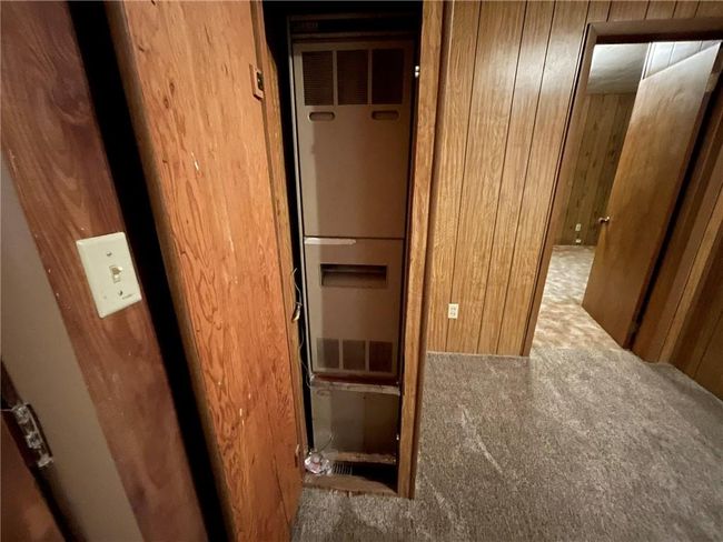 Hall featuring carpet flooring and wood walls | Image 11