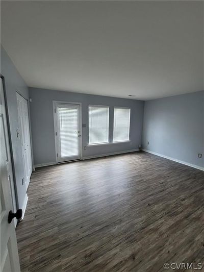 Unfurnished room with dark wood-type flooring and plenty of natural light | Image 2