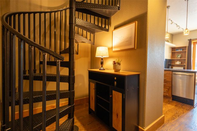 Staircase with wood finished floors and a textured wall | Image 12