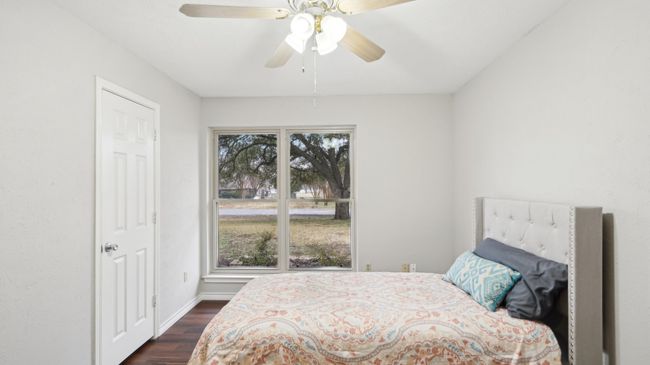 Bedroom with baseboards, dark wood-style floors, and a ceiling fan | Image 15