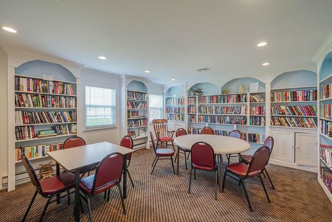 Carpeted dining room with ornamental molding, built in features, recessed lighting, and a baseboard heating unit | Image 31