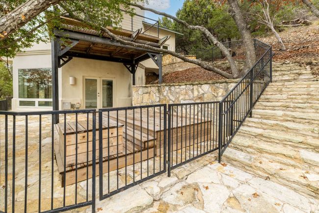Downstairs patio area offers a gate that goes to exterior walkway. | Image 26