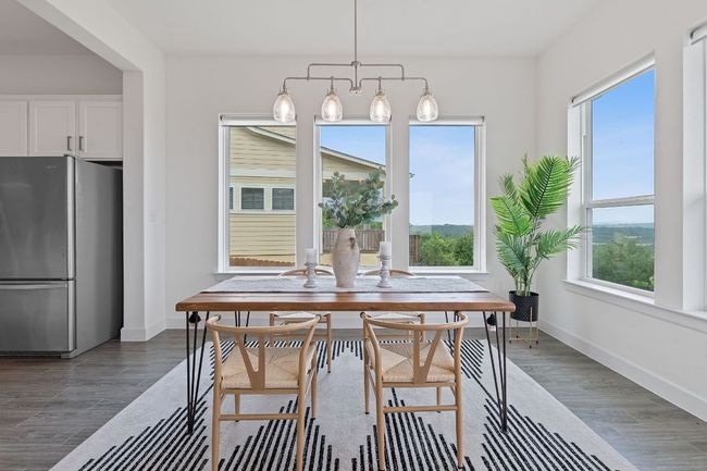 The dining area is a dream with the gorgeous hill country backdrop, space for a sizable dining table, and chandelier. | Image 17