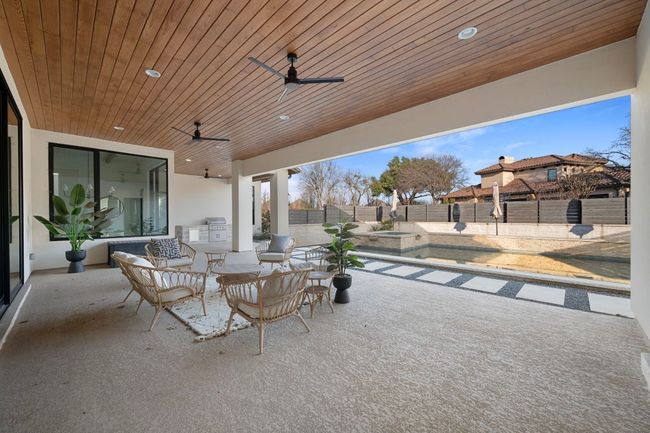 View of patio with ceiling fan and a fenced backyard | Image 33