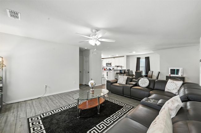 Living room featuring wood finished floors and a ceiling fan | Image 7