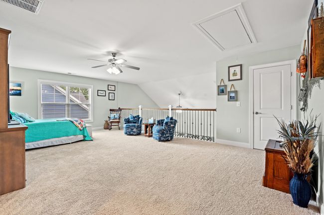 Bedroom featuring attic access, carpet flooring, and a ceiling fan | Image 22
