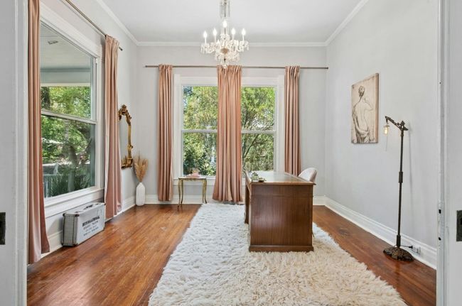 Office area featuring a chandelier, dark wood-style flooring, and crown molding | Image 20