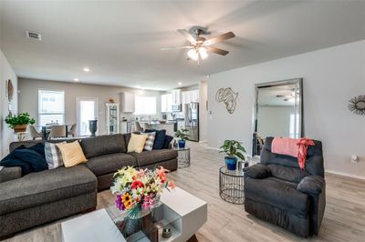 Living room with ceiling fan and light wood-type flooring | Image 2