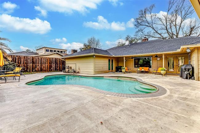 An expansive outdoor haven, the backyard unfolds around the shimmering pool and spa, offering a fully enclosed setting for both relaxation and entertainment. Generous open spaces provide the perfect canvas for lounging, dining, or creating your own private retreat under the open sky. | Image 39