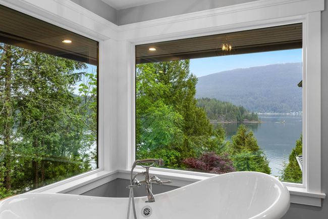 Full bath featuring a water and mountain view, a view of trees, and a soaking tub | Image 7