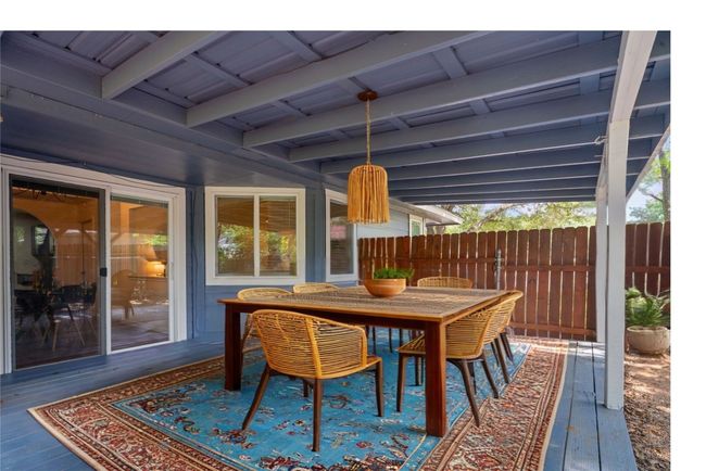 Covered back porch is virtually staged/revisioned as outdoor living room | Image 22