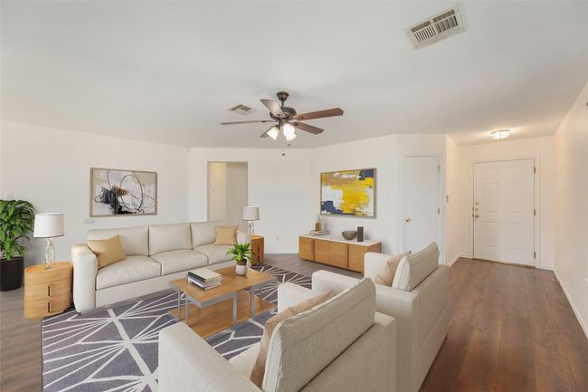 Living room with a ceiling fan and wood finished floors | Image 4