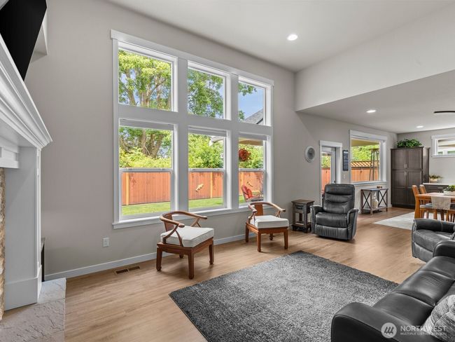The wall of windows in the living room flood this home with natural light. | Image 14