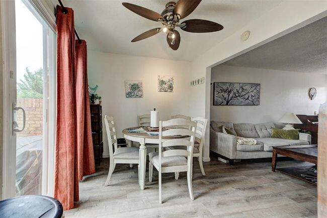Dining area featuring a ceiling fan and light wood-type flooring | Image 4