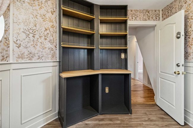 Mudroom featuring wallpapered walls, wood finished floors, and a wainscoted wall | Image 21