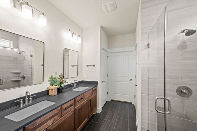 Bathroom with a shower stall, a sink, and double vanity | Image 23