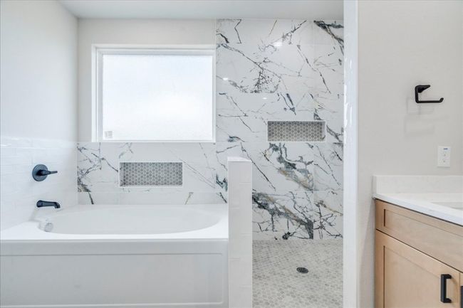 Full bath with a bath, a walk in shower, and vanity | Image 17