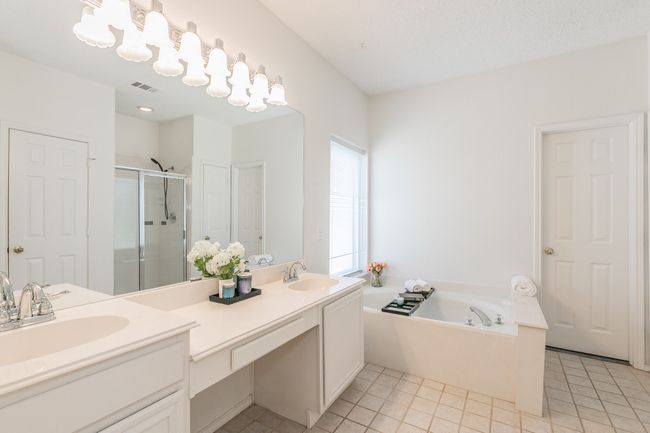 Full bathroom with a shower stall, visible vents, a garden tub, and a sink | Image 31