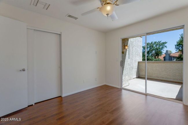 Bedroom #3 enjoys outdoor space on a balcony. | Image 39