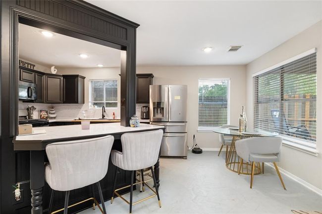 A closer look at the breakfast bar reveals a bold contrast—its black finish adds a pop of style that makes this feature stand out in the heart of the home. | Image 5
