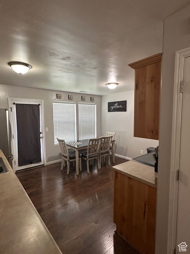 Dining room with baseboards and dark wood-type flooring | Image 6