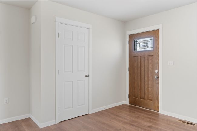Entryway with wood finished floors, baseboards, and visible vents | Image 29