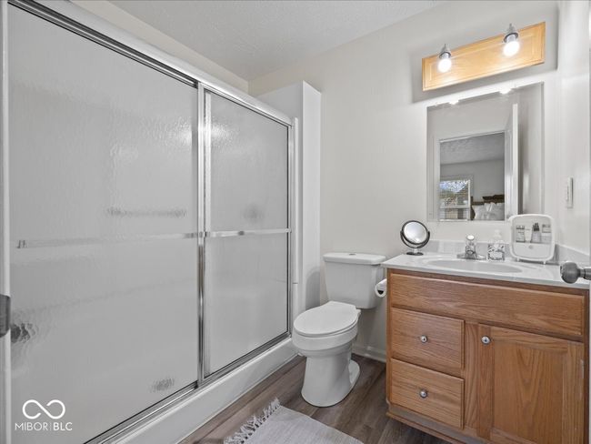 Primary bathroom with vanity, hardwood finished floors, and walk in shower | Image 13