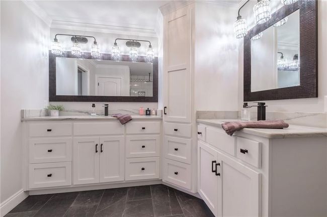 Bathroom with a shower, crown molding, and vanity | Image 15