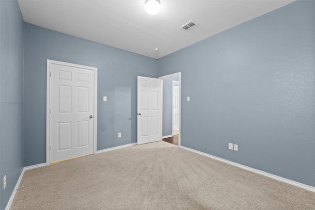 Unfurnished bedroom featuring baseboards, carpet, and visible vents | Image 32