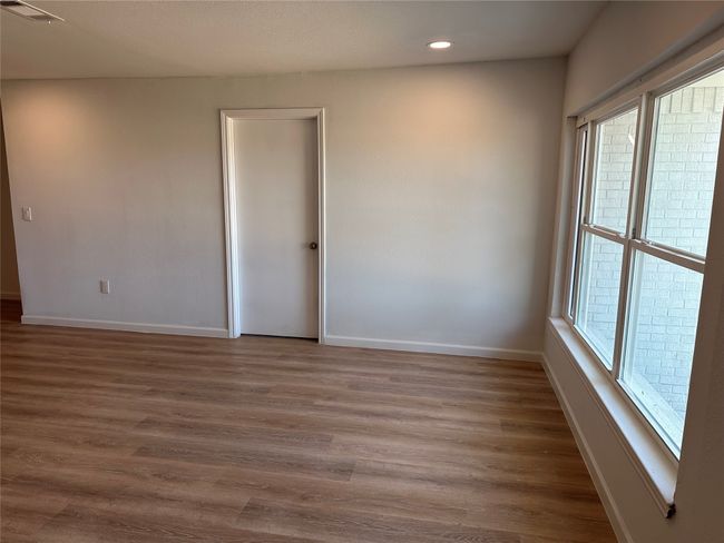 Empty room featuring visible vents, baseboards, wood finished floors, and recessed lighting | Image 13