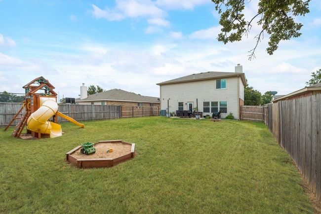 Fenced backyard with a playground | Image 26