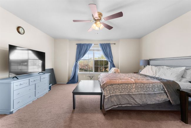 Bedroom with ceiling fan and light colored carpet | Image 14