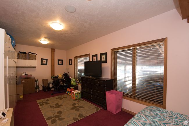 Bedroom with carpet and a textured ceiling | Image 63
