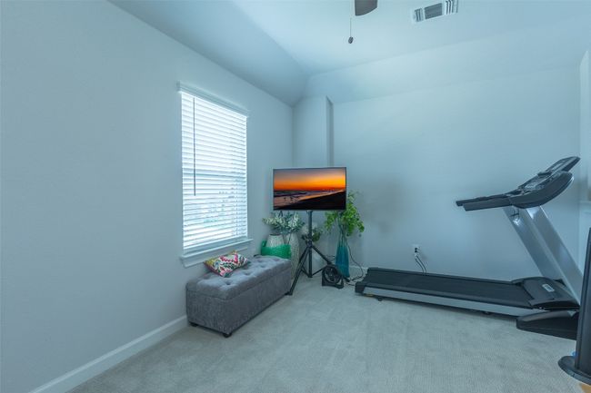 Exercise area with carpet flooring, plenty of natural light, a ceiling fan, and vaulted ceiling | Image 28