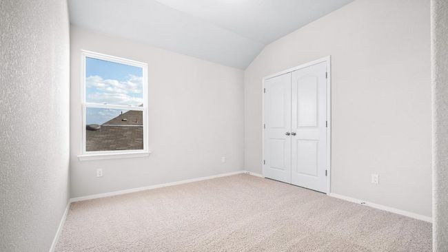 Unfurnished bedroom with carpet flooring, vaulted ceiling, and a closet | Image 7