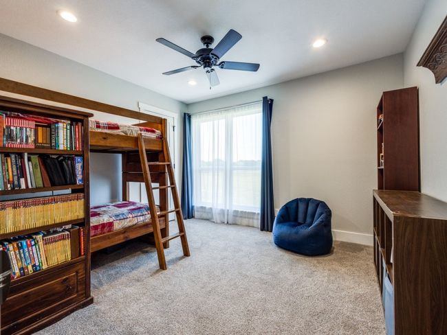 One of the two large guest bedrooms bedrooms--walk-in closet, recess lighting, fan, and a large window. Thick carpet pad make this floor so soft to walk on. | Image 20
