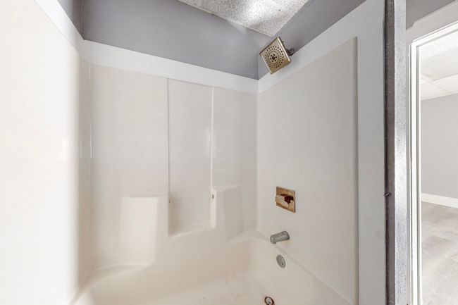 Bathroom featuring shower / washtub combination | Image 21