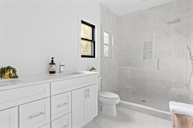Bathroom featuring vanity, an enclosed shower, and toilet | Image 12