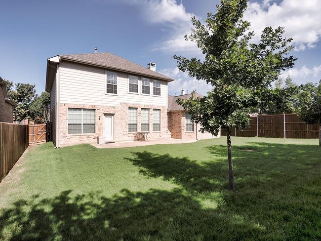 Rear view of property featuring brick siding, a patio, and a chimney | Image 40