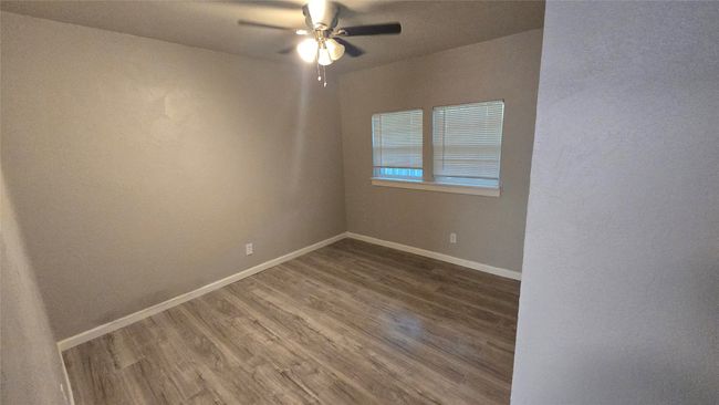 Spare room featuring wood finished floors and ceiling fan | Image 13